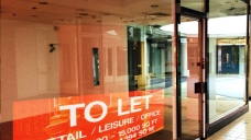 Empty shop unit with to let sign Empty shop unit with to let sign